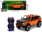 2021 Ford Bronco Open-Top Orange with Black Stripes and Hood with Extra Wheels "Just Trucks" Series 1/24 Diecast Model Car by Jada  free shipping USA